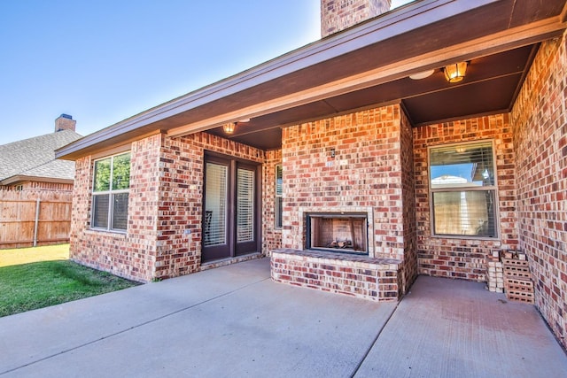 view of patio with an outdoor brick fireplace