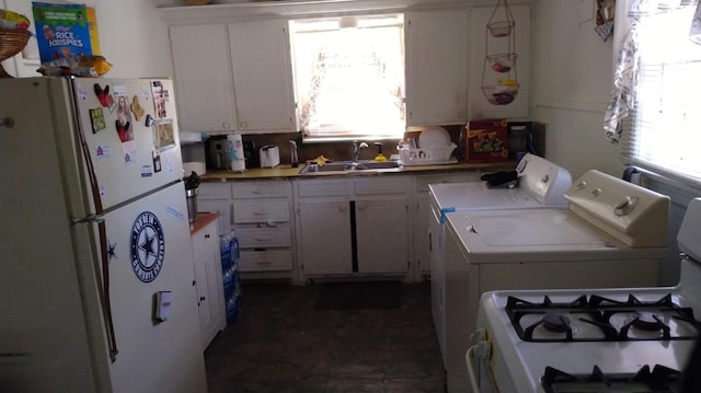 kitchen with white cabinetry, white appliances, independent washer and dryer, and sink