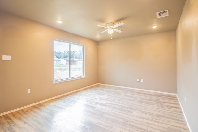 empty room with light hardwood / wood-style floors and ceiling fan