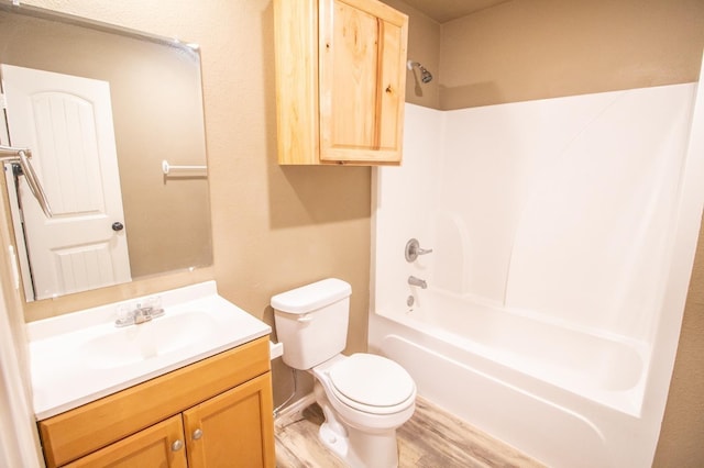 full bathroom featuring hardwood / wood-style flooring, shower / bathtub combination, vanity, and toilet