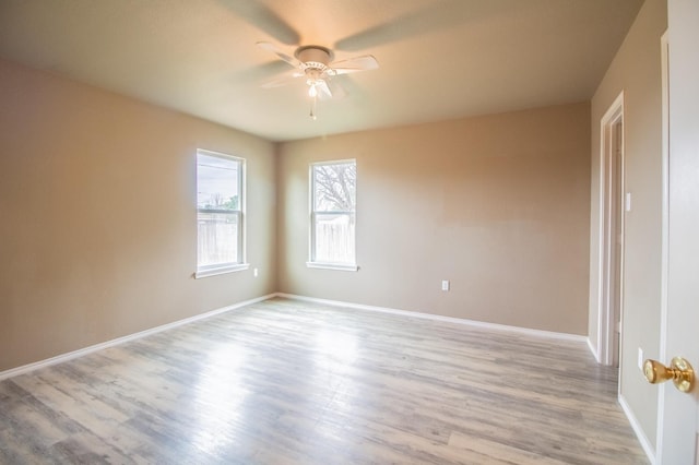 spare room with ceiling fan and light hardwood / wood-style floors