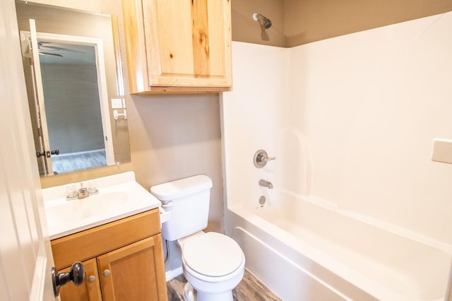 full bathroom with vanity, hardwood / wood-style flooring, bathing tub / shower combination, and toilet