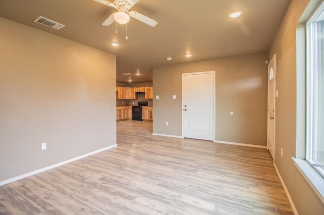 spare room featuring light hardwood / wood-style floors and ceiling fan