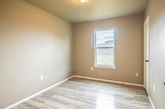 spare room featuring light hardwood / wood-style floors