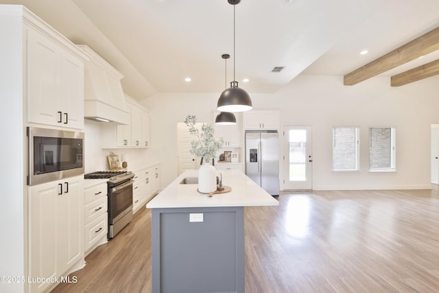 5005 Prentiss Ave, Lubbock, TX 79407 - kitchen with stainless steel appliances, light wood-style flooring, recessed lighting, light countertops, and white cabinets