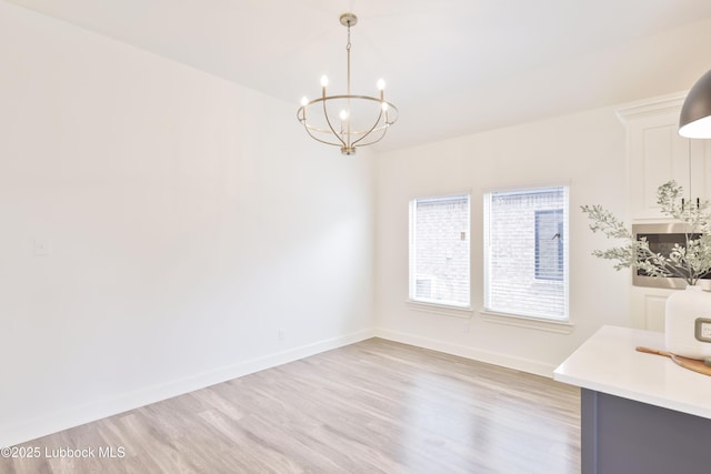 5005 Prentiss Ave, Lubbock, TX 79407 - unfurnished dining area featuring light wood-type flooring and a chandelier