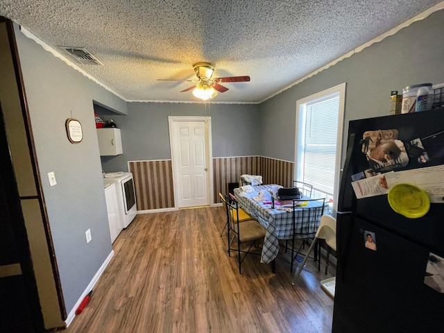 dining space with crown molding, ceiling fan, washer and dryer, a textured ceiling, and dark hardwood / wood-style flooring