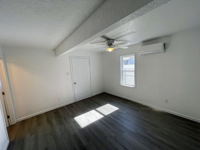 unfurnished bedroom featuring dark hardwood / wood-style flooring, a wall mounted air conditioner, a textured ceiling, and ceiling fan