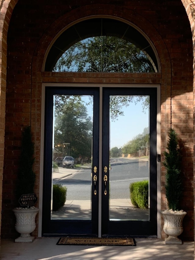 doorway featuring brick wall