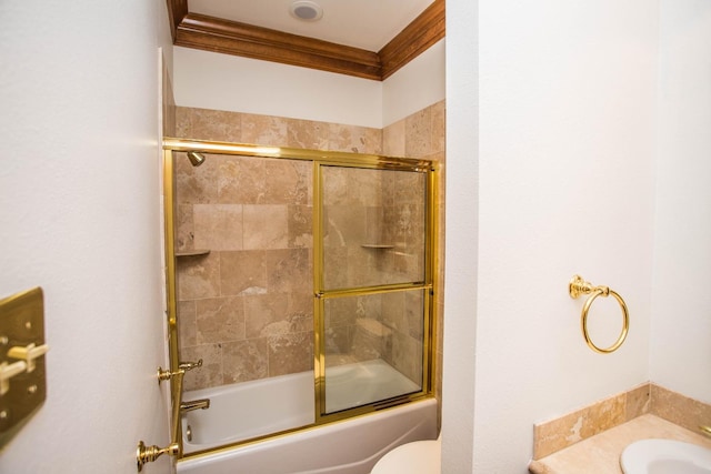 full bathroom with toilet, ornamental molding, shower / bath combination with glass door, and sink