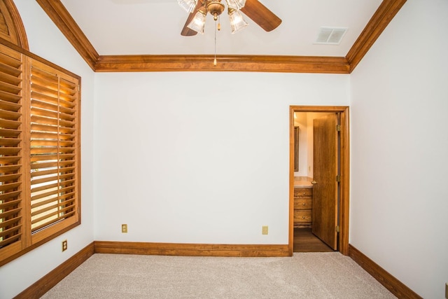 carpeted empty room with ornamental molding and ceiling fan