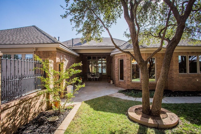 view of front of property with a patio area and a front yard