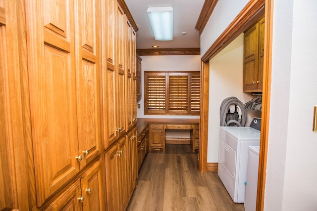 laundry room with cabinets, light hardwood / wood-style flooring, ornamental molding, and washer and dryer