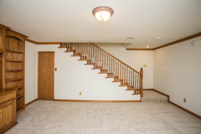 interior space with light colored carpet and ornamental molding