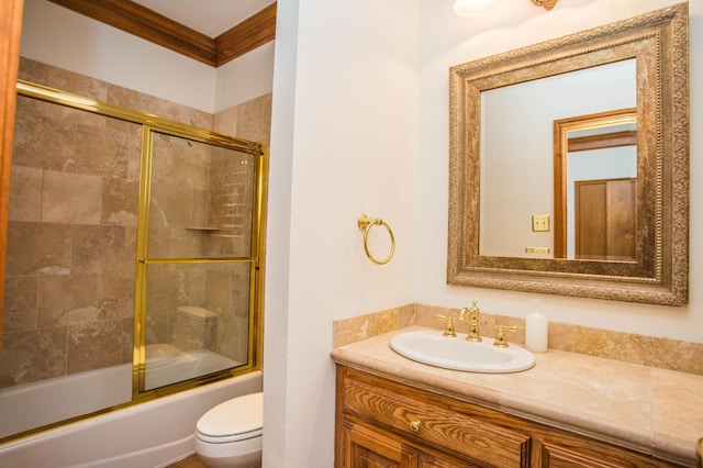 full bathroom with crown molding, vanity, shower / bath combination with glass door, and toilet