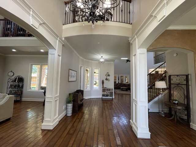 4009 109th St, Lubbock, TX 79423 - foyer with arched walkways, ornate columns, stairway, plenty of natural light, and a high ceiling