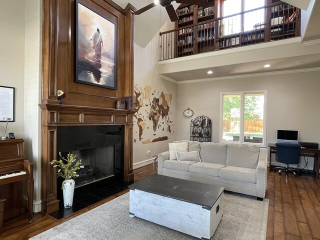 4009 109th St, Lubbock, TX 79423 - living area featuring ornamental molding, wood finished floors, a fireplace with flush hearth, ceiling fan, and a high ceiling