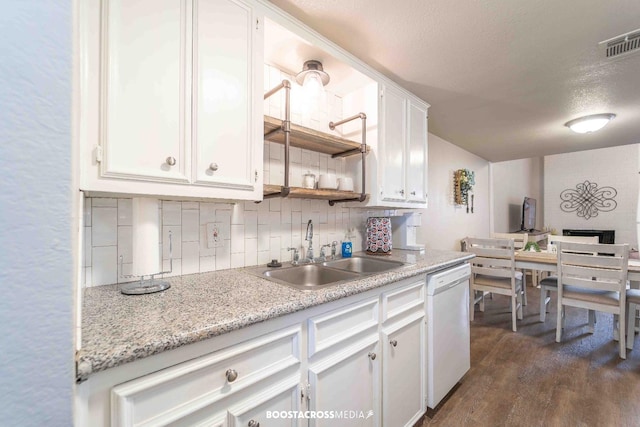 kitchen with sink, dishwasher, white cabinetry, dark hardwood / wood-style flooring, and decorative backsplash