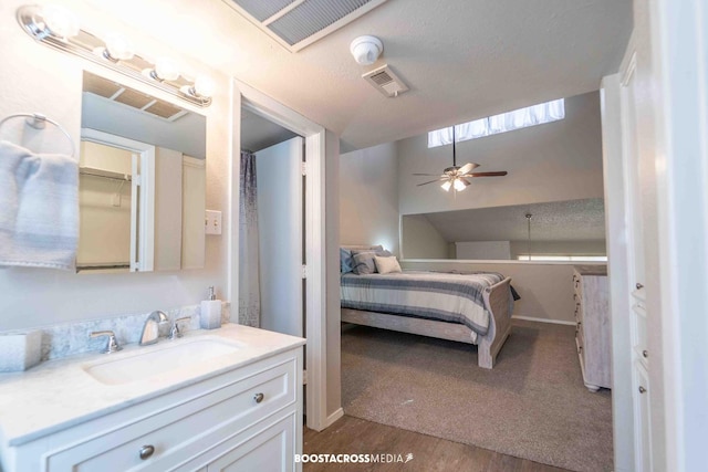 bedroom featuring sink, hardwood / wood-style flooring, and a textured ceiling