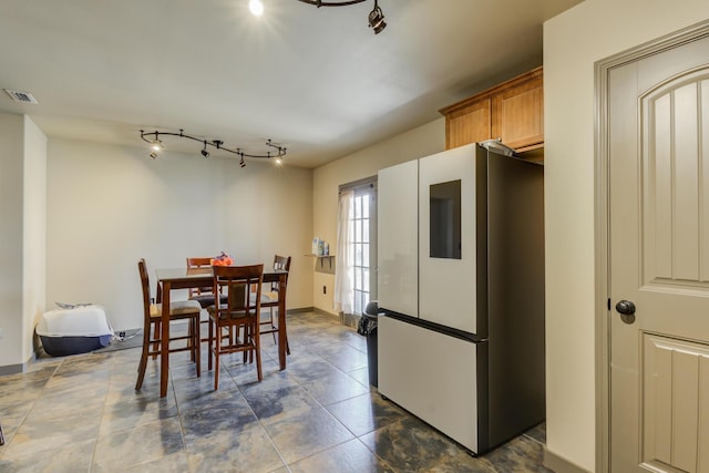 6208 21st St, Lubbock, TX 79407 - dining space featuring rail lighting, baseboards, and visible vents