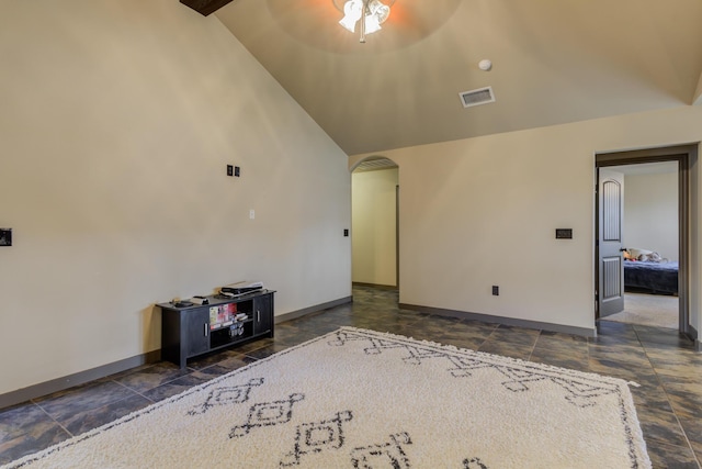 6208 21st St, Lubbock, TX 79407 - unfurnished living room featuring stone finish floor, visible vents, baseboards, arched walkways, and lofted ceiling