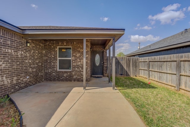 6208 21st St, Lubbock, TX 79407 - entrance to property featuring brick siding, fence, and a patio