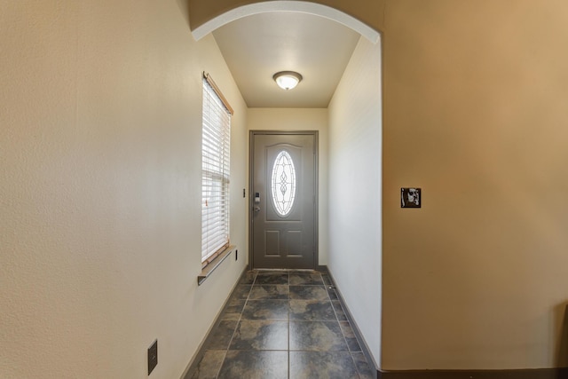6208 21st St, Lubbock, TX 79407 - entryway featuring arched walkways, baseboards, and stone finish flooring