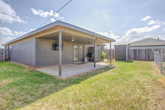 6208 21st St, Lubbock, TX 79407 - back of house featuring a patio, a lawn, a fenced backyard, and a storage unit
