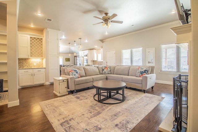 living room with crown molding, dark wood-type flooring, and ceiling fan