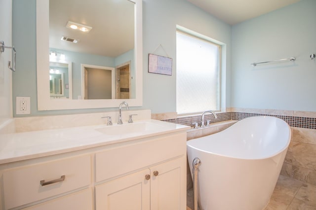 bathroom featuring vanity, a bathtub, and tile walls