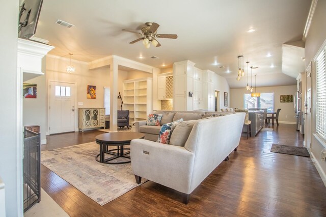 living room with lofted ceiling, dark hardwood / wood-style floors, and ceiling fan