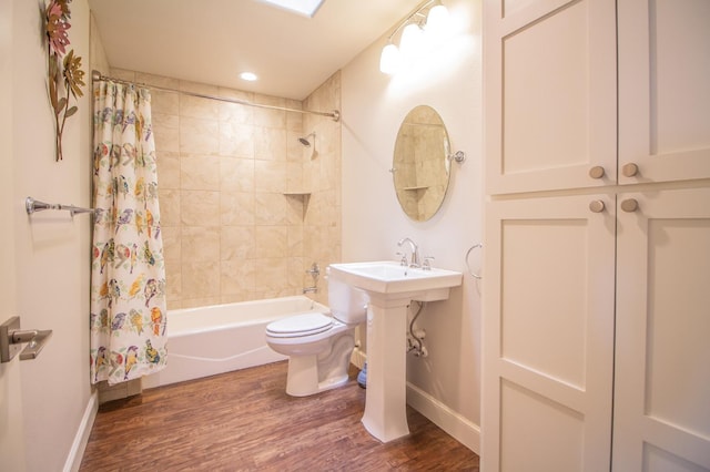 bathroom with hardwood / wood-style flooring, toilet, and shower / bath combo with shower curtain