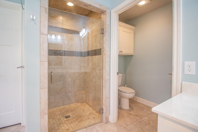 bathroom with an enclosed shower, vanity, and toilet