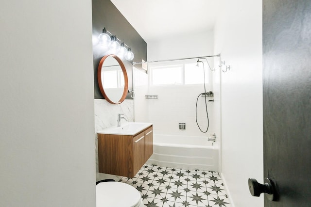 full bathroom with vanity, tiled shower / bath, and toilet