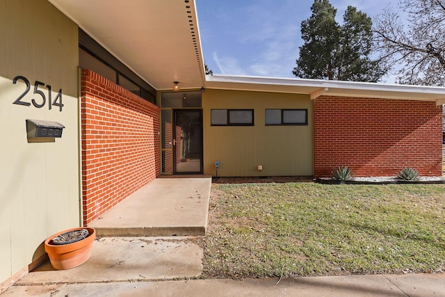 doorway to property featuring a yard