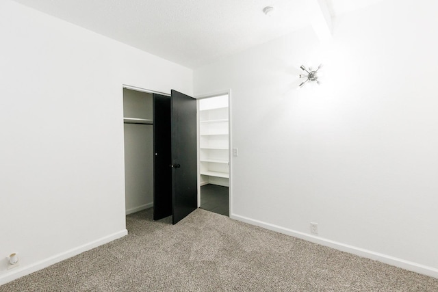 unfurnished bedroom with a closet and carpet flooring