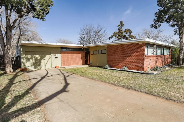 ranch-style house featuring a garage and a front yard