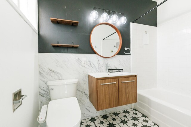 full bathroom with shower / tub combination, vanity, and toilet