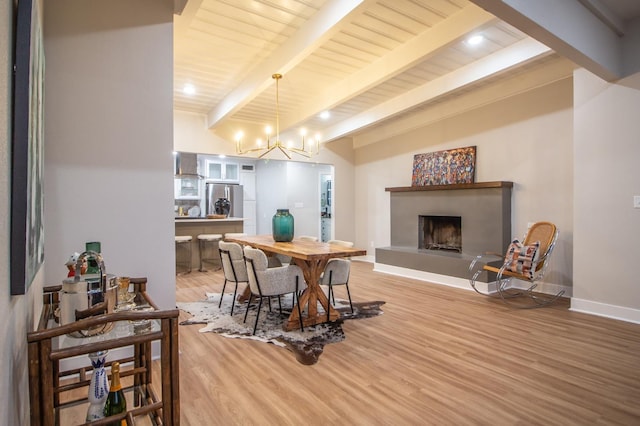 dining space featuring wood ceiling, beam ceiling, a chandelier, and hardwood / wood-style floors