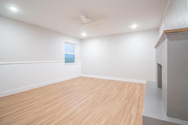 empty room with ceiling fan and light wood-type flooring