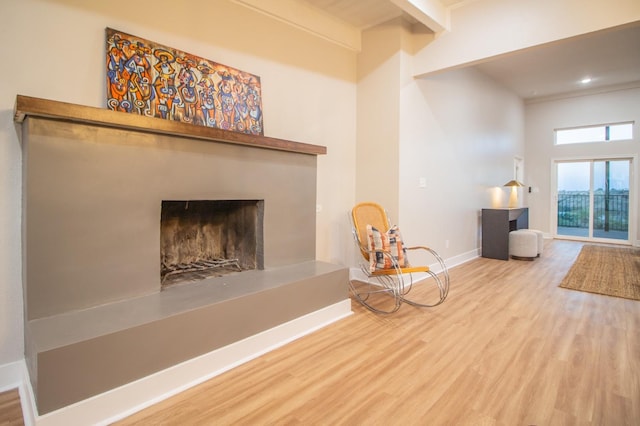 unfurnished room featuring wood-type flooring and beamed ceiling