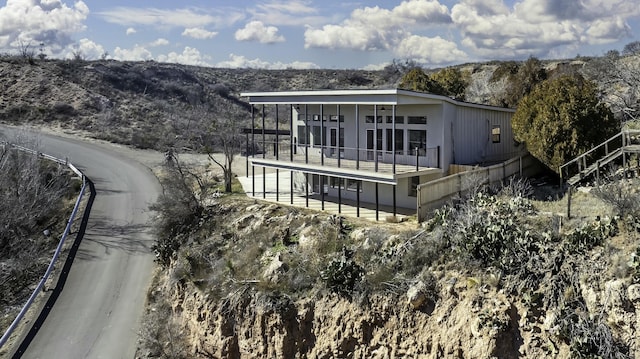 back of house featuring a balcony