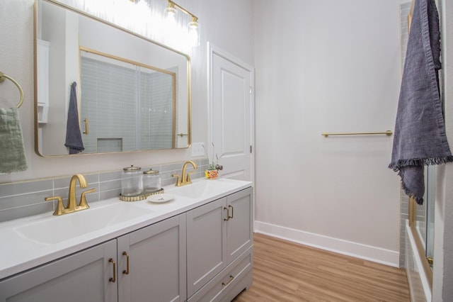 bathroom with vanity, hardwood / wood-style floors, decorative backsplash, and walk in shower