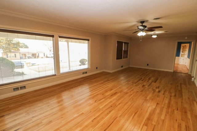 empty room with crown molding, ceiling fan, and light hardwood / wood-style flooring