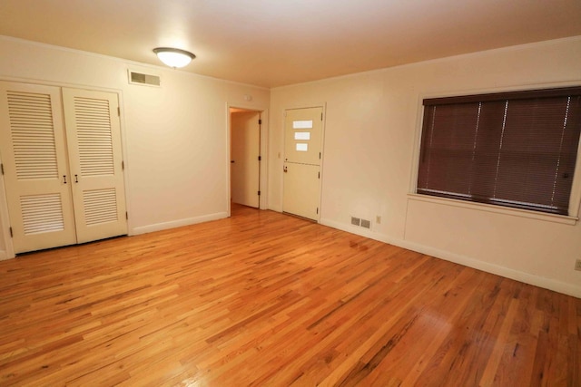 interior space featuring ornamental molding, light hardwood / wood-style floors, and french doors