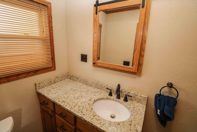 bathroom with vanity and toilet