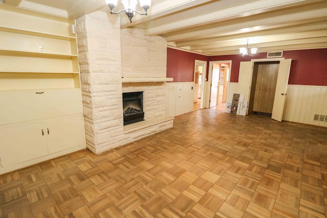 unfurnished living room with parquet flooring, a fireplace, and an inviting chandelier