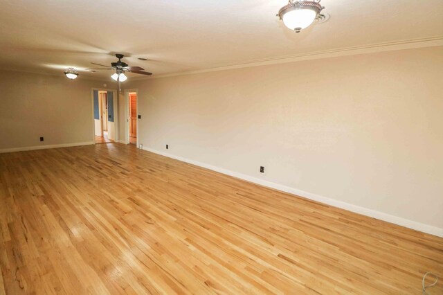 spare room featuring crown molding, light hardwood / wood-style flooring, and ceiling fan