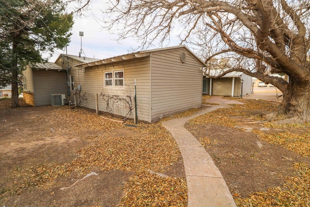 view of side of home with central AC unit