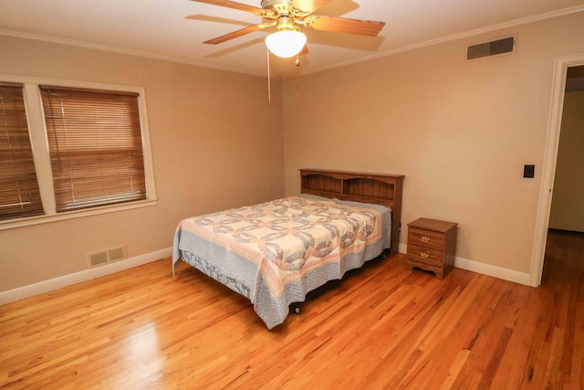 bedroom with crown molding, ceiling fan, and light hardwood / wood-style floors